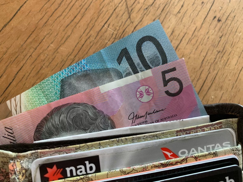 Australian wallet with cash and bank cards — savings from switching energy plans